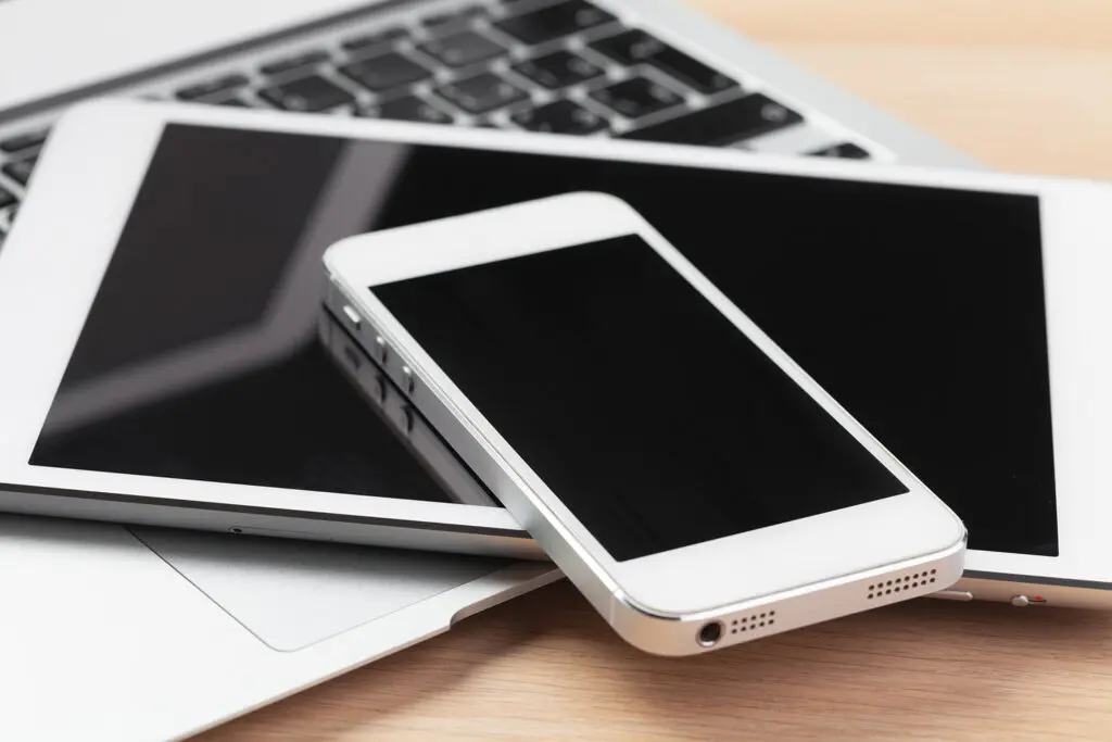 Open laptop with digital tablet and smartphone