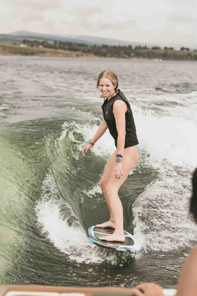 Four Seasons Motorsports & Marine person surfing behind wake boat - photography and video