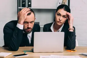 stressed business people looking at a bad business website