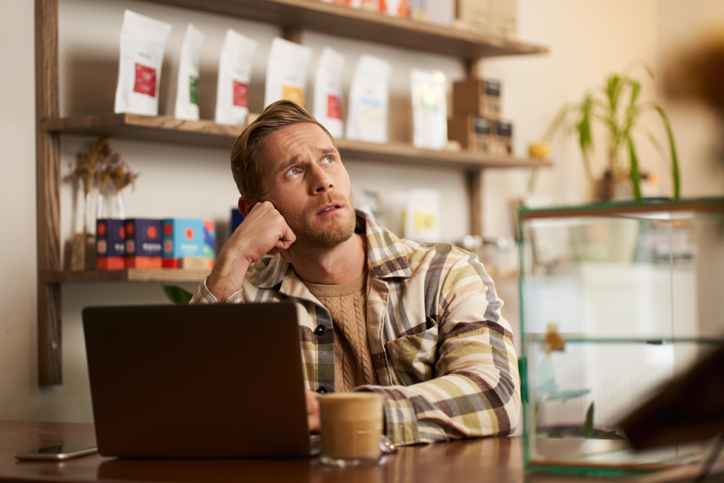 man thinking hard at laptop