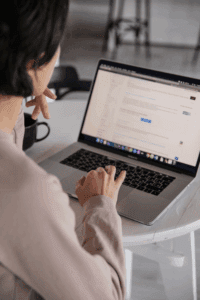 Woman using search engine on laptop to look up businesses