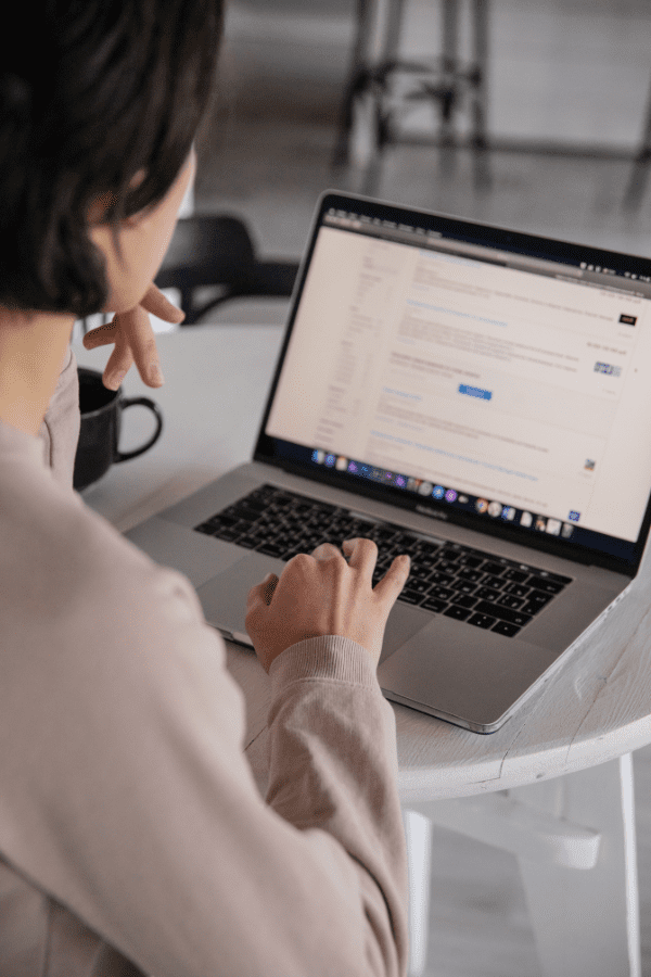 Woman using search engine on laptop to look up businesses
