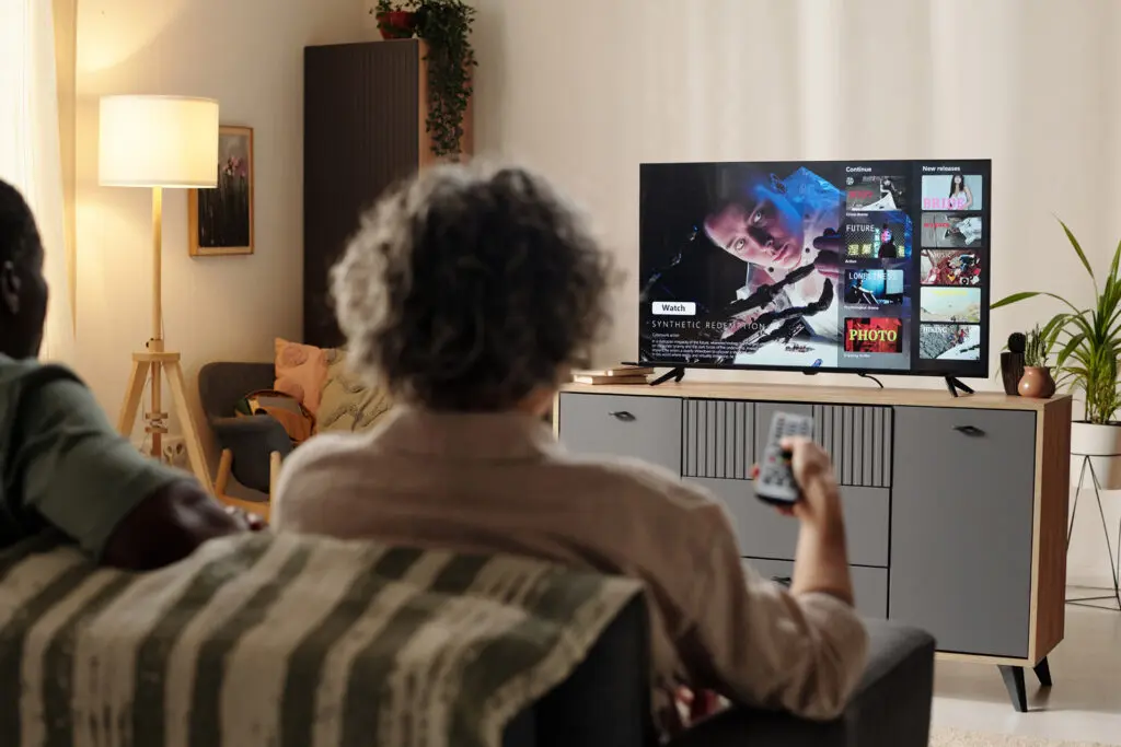 Couple-sitting-down-to-watch-a-show-on-a-streaming-service