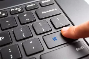 finger pressing enter button on keyboard