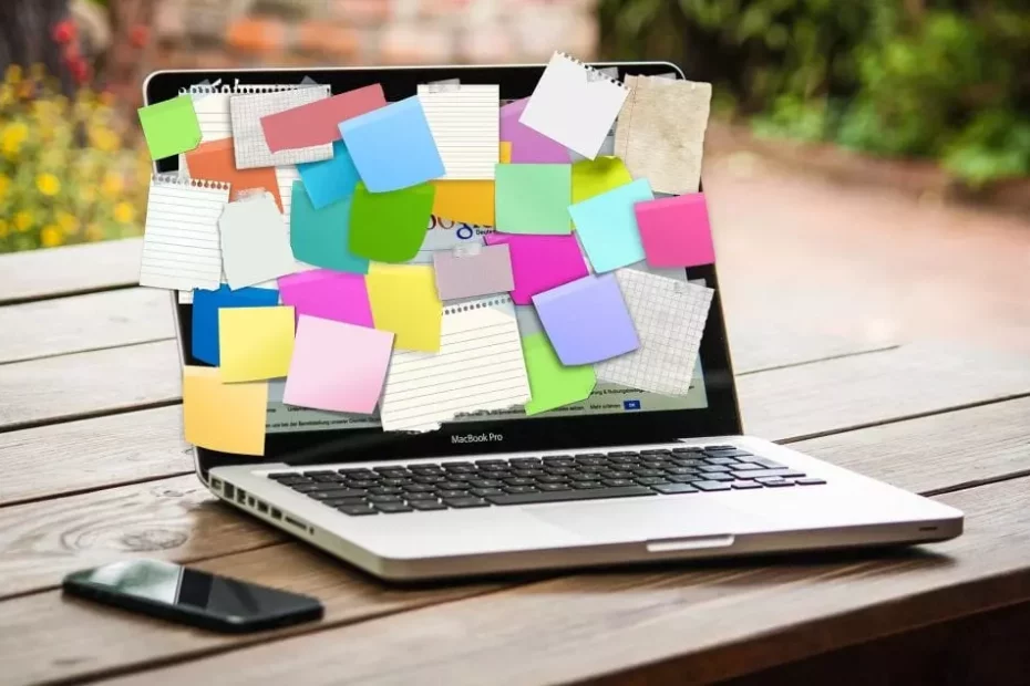 laptop with sticky notes covering the display
