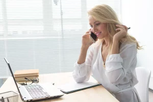 woman on the phone holding pen