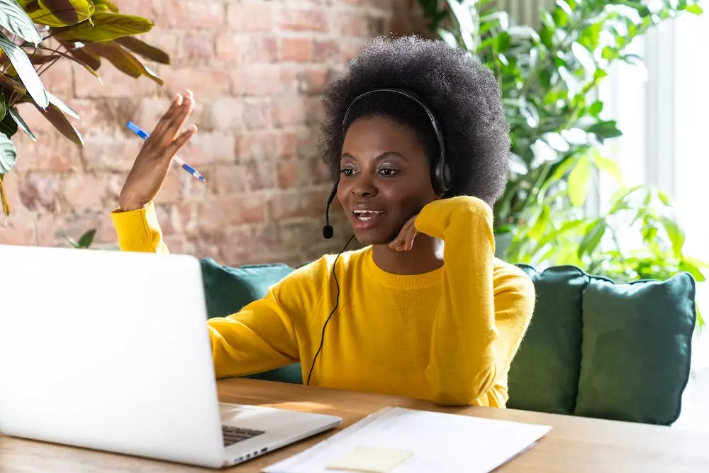 woman employee wearing headphones on computer