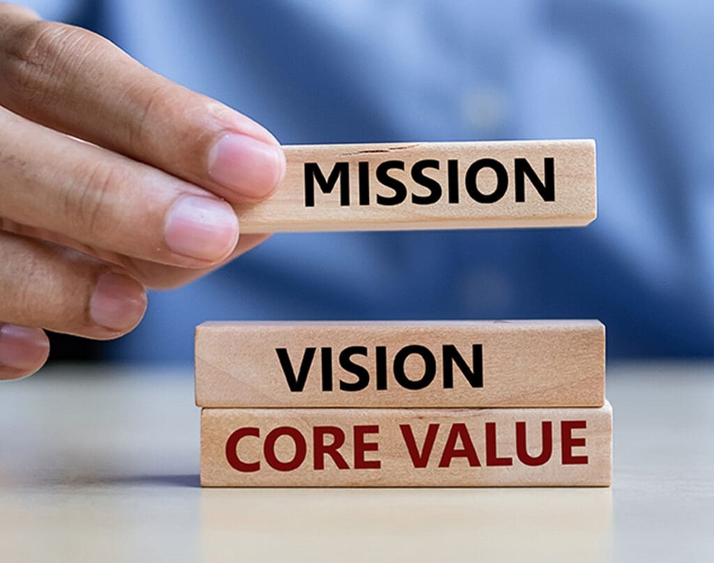 Mission, vision, core value words written on wooden blocks being stacked