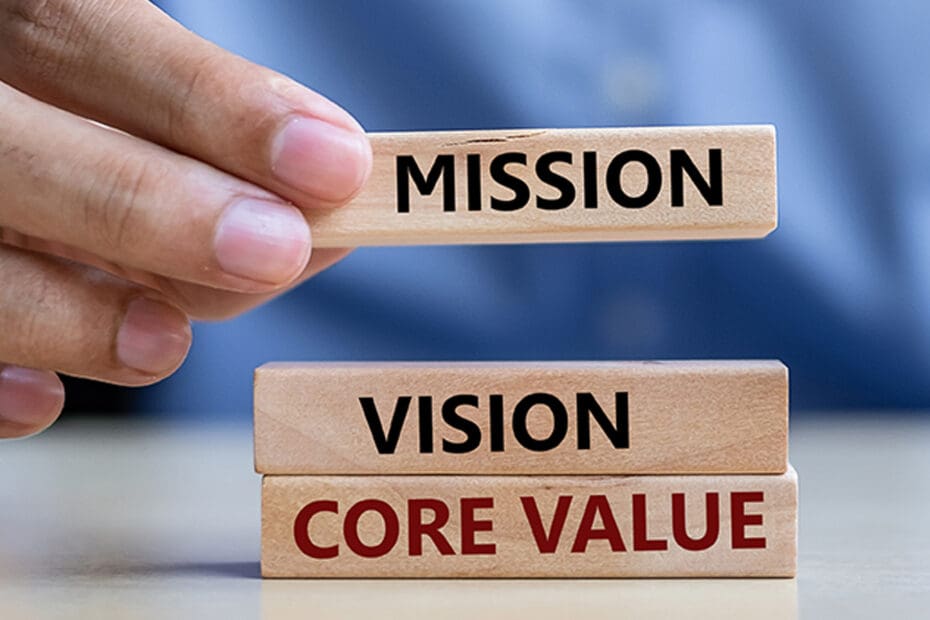 Mission, vision, core value words written on wooden blocks being stacked